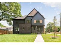 Stunning two-story home with a combination of modern siding and brick accents at 4900 Doris Ave, Charlotte, NC 28205