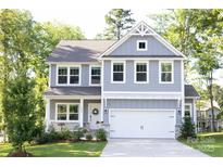 Charming two-story home with a covered porch, attached garage, and well-maintained landscaping at 5499 Angus Dr, Midland, NC 28107