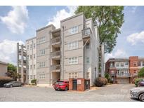 Exterior of a well-maintained apartment building featuring multiple balconies and a secure entrance at 558 Oakland Ave, Charlotte, NC 28204