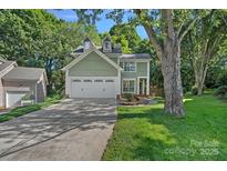 Charming two-story home with a well-manicured lawn and attached two-car garage at 807 Water Wheel Ct, Charlotte, NC 28209