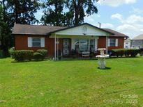 Charming single-story brick home with a well-maintained lawn and inviting front porch at 814 Aileen Cir, Pineville, NC 28134