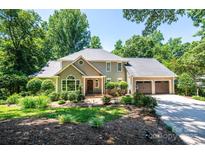 Charming two-story home featuring a well-manicured lawn and a three-car garage at 841 16Th Avenue Nw Ln, Hickory, NC 28601