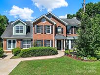 Charming two-story brick home features manicured landscaping and a welcoming front entrance at 9800 Ashley Farm Dr, Matthews, NC 28105