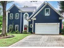 Charming two-story home featuring a 2-car garage, well-maintained lawn, and navy blue siding for great curb appeal at 103 Pamlico Ln, Mooresville, NC 28117