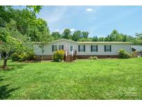 Traditional home featuring mature trees, an inviting porch, and a well-maintained lawn at 1495 Leonards Fork Church Rd, Lincolnton, NC 28092