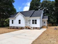 Charming newly built home featuring white siding, dark roof, and a spacious concrete driveway at 2051 Highwood Rd, Rock Hill, SC 29732