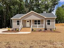 Charming single-story home with a welcoming front porch and manicured lawn at 2063 Highwood Rd, Rock Hill, SC 29732