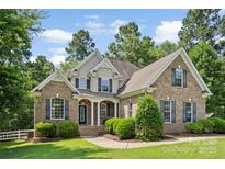 Charming two-story brick home with a well-manicured lawn and inviting front porch at 2074 Brandt Rd, York, SC 29745