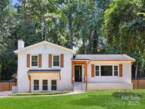 Charming white brick home with a well-manicured lawn and inviting wood shutters at 2120 Shadyview Dr, Charlotte, NC 28210
