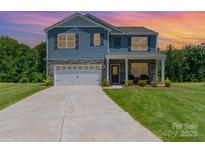 Charming two-story home featuring stone accents, attached two-car garage, and manicured lawn at 3654 Azalea Ridge Dr, Mount Holly, NC 28102