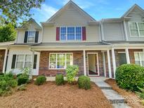 Charming townhouse with brick and siding facade, complemented by a well-manicured lawn at 5163 Ficus Tree Ln, Charlotte, NC 28215