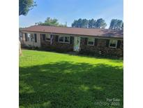 Charming brick home with a large, well-maintained front yard and inviting curb appeal at 111 Redwood Ln, Gastonia, NC 28052