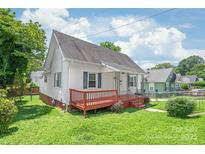 Charming one story home with a red porch and freshly cut lawn, perfect for enjoying a beautiful day at 1113 W 4Th Ave, Gastonia, NC 28052