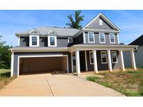 New two-story home with a two car garage and a covered front porch with classic white columns at 118 Still Creek Dr, Mooresville, NC 28115