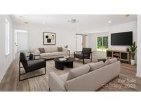 Inviting living room with ample seating, modern decor, and large sliding doors offering scenic views at 157 Fraley Rd, Gastonia, NC 28052