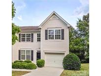 Charming two-story home featuring a front-entry garage, well-maintained landscaping, and classic architectural details at 2150 Winthrop Chase Dr, Charlotte, NC 28212