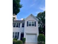 Charming two-story home featuring a neutral facade, attached garage and landscaped front yard at 2150 Winthrop Chase Dr, Charlotte, NC 28212