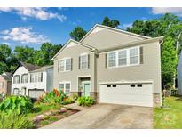Charming two-story home featuring a two car garage, landscaped yard, and a light blue front door at 2926 Royal Fern Ln, Charlotte, NC 28215