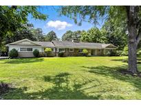 Expansive ranch-style home featuring a large, well-maintained lawn and mature trees at 3127 N Center St, Hickory, NC 28601
