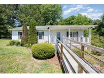 Charming single-story home with a covered porch and accessible ramp at 38367 Loblolly Ln, New London, NC 28127