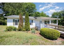 Charming one-story home with landscaped front yard, porch and accessible ramp at 38367 Loblolly Ln, New London, NC 28127