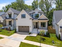 Beautiful two-story home with white siding, black trim, and a two-car garage at 3945 Plainview Rd, Charlotte, NC 28208