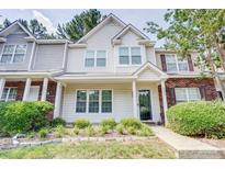 Charming townhome featuring manicured landscaping and a welcoming front entrance at 5909 Cougar Ln, Charlotte, NC 28269