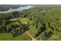 Stunning aerial view of the lake property with lush greenery and serene surroundings at 746 Joe Lentz Rd, Salisbury, NC 28146