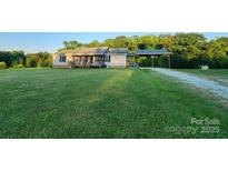 Ranch home with covered parking on a large, grassy lot at 746 Joe Lentz Rd, Salisbury, NC 28146