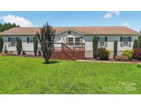 Charming single-story home with a welcoming front deck and well-maintained lawn at 1069 Heather Glen Dr, Catawba, NC 28609