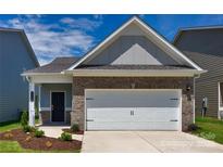 Charming brick home featuring a two-car garage with a white door and black decorative hardware at 1225 Langston Ln, Salisbury, NC 28144