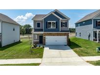 Charming two-story home featuring stone accents, a two-car garage, and a well-manicured lawn at 1237 Langston Ln, Salisbury, NC 28144