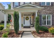 Inviting front door with a decorative wreath and charming landscaping at 137 Branchview Dr, Mooresville, NC 28115