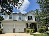 Charming two-story home featuring a two-car garage and stone accents, complemented by lush landscaping at 15508 Normans Landing Dr, Charlotte, NC 28273
