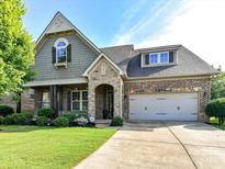 Charming brick and stone home with a well-manicured lawn and inviting front entrance at 2005 Arbor Hills Dr, Indian Trail, NC 28079