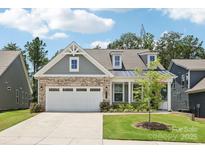 Charming home with a well-manicured lawn, three-car garage, and a blend of brick and siding accents at 3022 Trace Meadow Ct, York, SC 29745