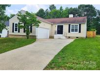 Charming one-story home featuring a long driveway, attached garage, and well-manicured lawn at 3106 Faircroft Way, Monroe, NC 28110