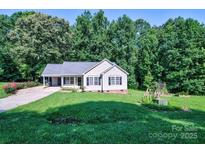 Charming single-story home featuring well-manicured lawn and covered porch at 5437 Mallard Ln, Gastonia, NC 28052