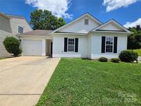 Charming single-story home with well-manicured lawn and attached single-car garage at 7315 Fig Ln, Charlotte, NC 28215