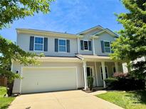 Charming two-story home with a two-car garage, a front porch, and lovely landscaping in a suburban neighborhood at 11109 Pond Valley Ct, Charlotte, NC 28269