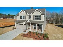 Charming two-story home featuring a two-car garage, well-manicured landscaping and a welcoming front porch at 2202 Millennium Dr # 89, Lancaster, SC 29720