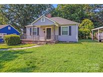 Charming one story home with an inviting porch and fresh green lawn at 2405 Greenland Ave, Charlotte, NC 28208