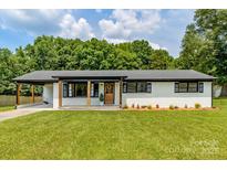 Charming, renovated ranch home with a lovely, welcoming front yard and a brick exterior at 2610 Fairgreen Dr, Gastonia, NC 28056