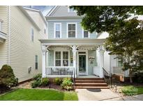 Charming two-story home featuring a welcoming front porch with lovely landscaping and a brick stairway to the entrance at 298 Bridges Farm Rd, Mooresville, NC 28115