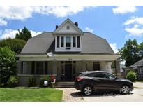 Charming two-story home with a covered front porch and well-manicured lawn at 318 N Laurel N St, Lincolnton, NC 28092