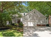 Traditional home with neutral siding, attached two-car garage, and mature landscaping at 9141 Covey Hollow Ct, Charlotte, NC 28210