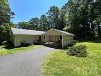 Charming single story home with a carport and a long driveway surrounded by mature trees at 1010 Macarthur Rd, Albemarle, NC 28001