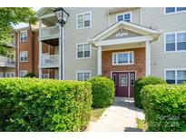 Inviting condo exterior with well-maintained landscaping and private balcony at 10614 Hill Point Ct, Charlotte, NC 28262