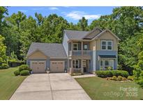 Charming two-story home with a spacious three-car garage and beautifully landscaped front yard at 1209 Shelly Woods Dr, Indian Land, SC 29707