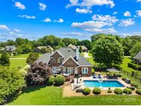 Stunning aerial view of backyard with beautiful pool, deck, and manicured lawn at 132 Broadbill Dr, Mooresville, NC 28117